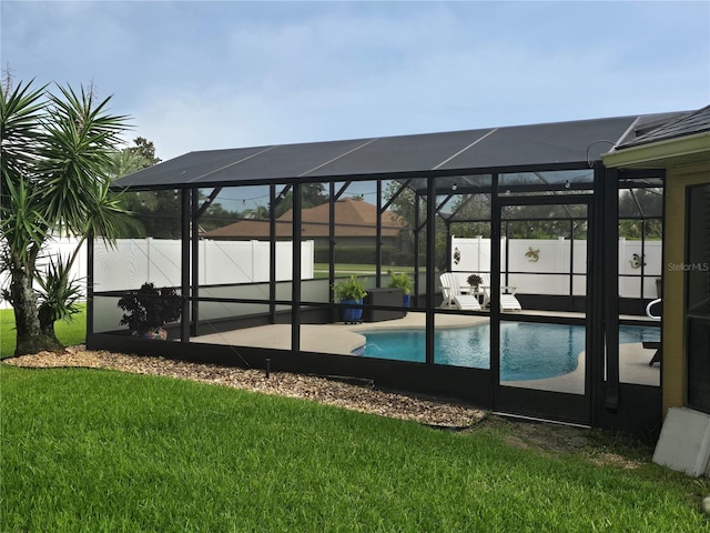 dock area featuring a yard, a patio, a fenced in pool, and a lanai