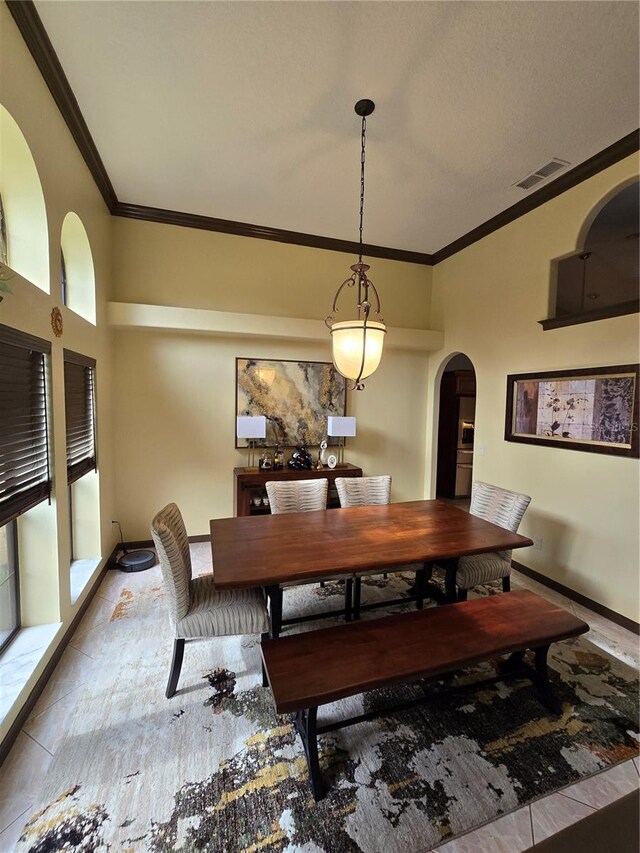 dining space featuring crown molding