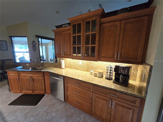 kitchen featuring sink, light stone counters, dishwasher, and light tile patterned floors