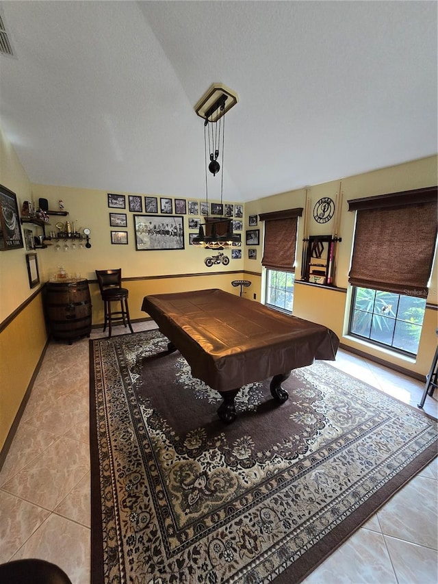 recreation room with light tile patterned flooring, vaulted ceiling, a textured ceiling, and billiards