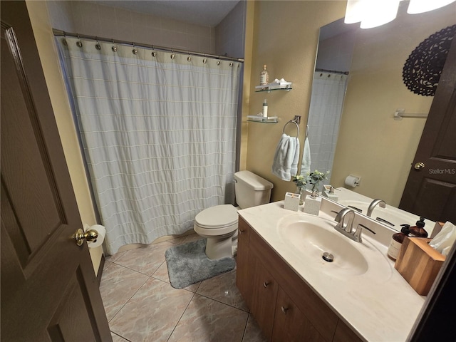 bathroom featuring tile patterned floors, vanity, and toilet