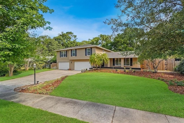 tri-level home featuring a garage and a front lawn