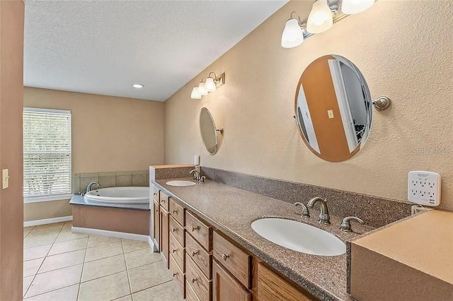 bathroom with vanity, a washtub, tile patterned floors, and a textured ceiling