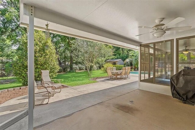 view of patio / terrace with grilling area, a sunroom, and ceiling fan