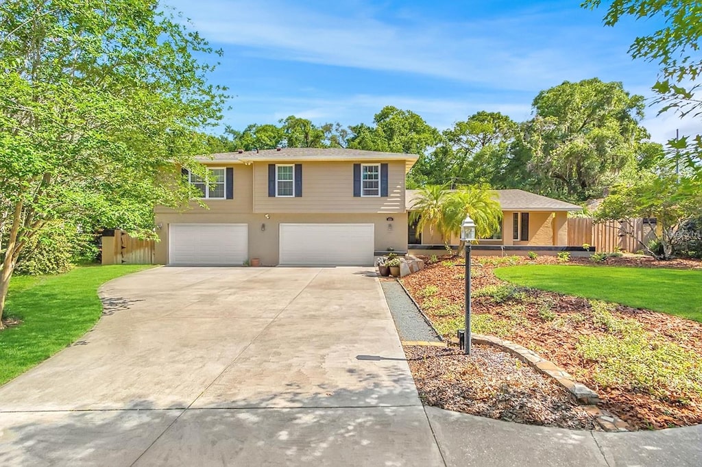 view of front of home with a garage and a front lawn