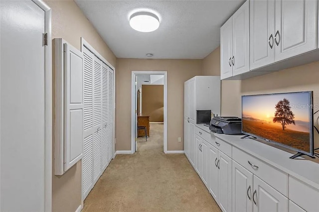 hallway with light colored carpet