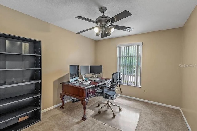 carpeted office featuring ceiling fan and a textured ceiling