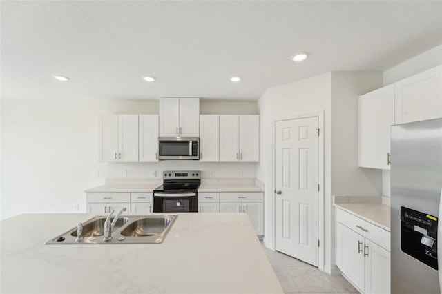 3824 Giorgio Dr, Winter Haven, FL 33884 - kitchen with appliances with stainless steel finishes, a sink, white cabinets, and recessed lighting