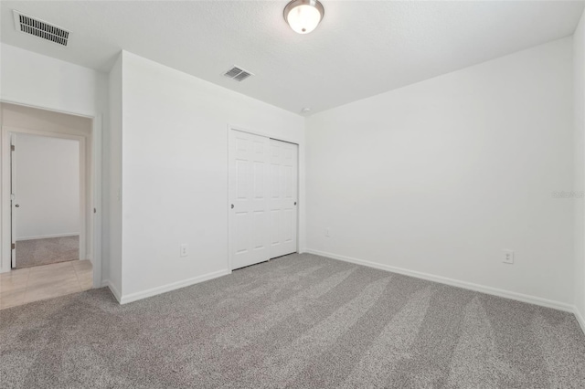 3824 Giorgio Dr, Winter Haven, FL 33884 - unfurnished bedroom featuring carpet flooring, baseboards, and a closet