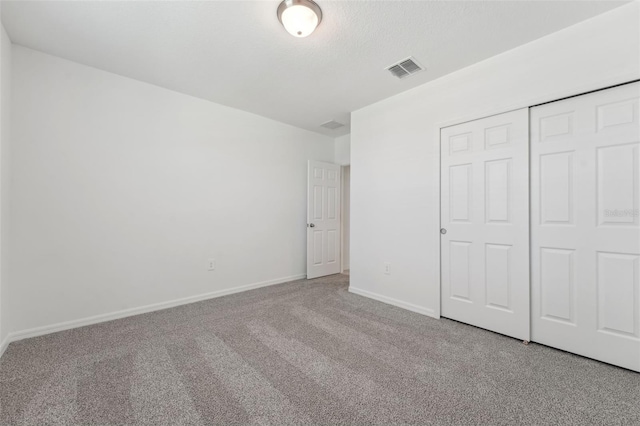 3824 Giorgio Dr, Winter Haven, FL 33884 - unfurnished bedroom featuring carpet flooring, baseboards, and a closet