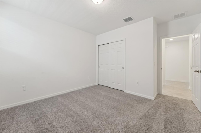 3824 Giorgio Dr, Winter Haven, FL 33884 - unfurnished bedroom with carpet flooring, baseboards, and a closet