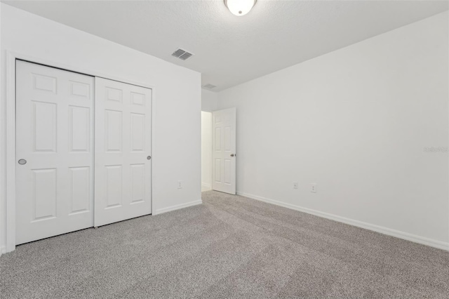 3824 Giorgio Dr, Winter Haven, FL 33884 - unfurnished bedroom featuring carpet floors, baseboards, and a closet