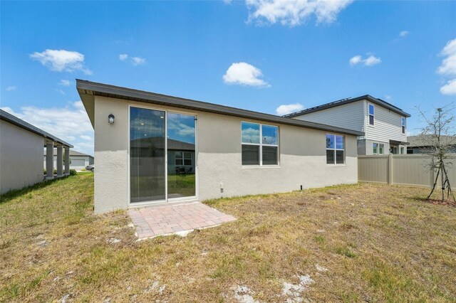3824 Giorgio Dr, Winter Haven, FL 33884 - rear view of property featuring stucco siding and a patio