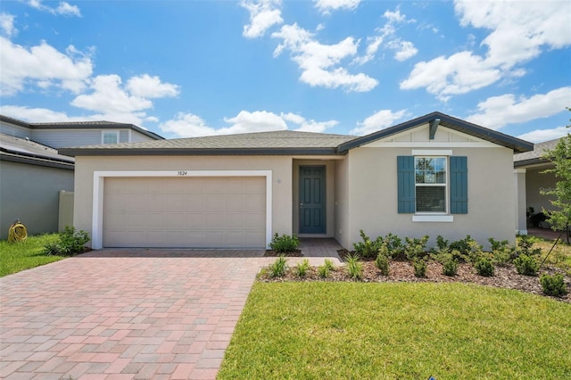 3824 Giorgio Dr, Winter Haven, FL 33884 - ranch-style home with decorative driveway, an attached garage, stucco siding, and a front lawn