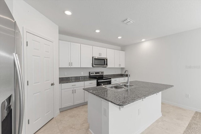 kitchen featuring white cabinets, an island with sink, stainless steel appliances, and sink