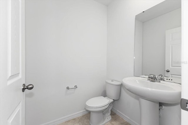 bathroom featuring toilet and tile patterned floors