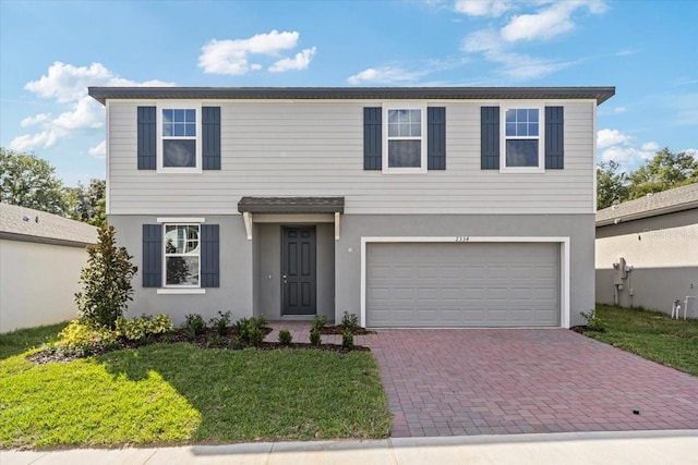 view of front of house with a front yard and a garage