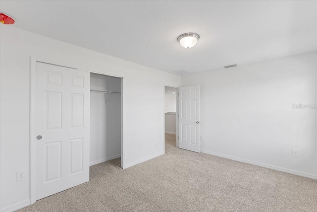 unfurnished bedroom featuring a closet and carpet floors