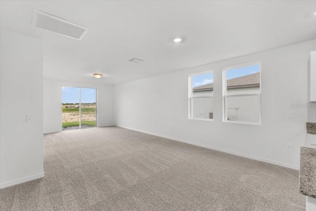 carpeted empty room with baseboards