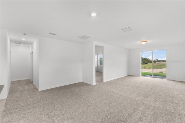 empty room with visible vents, baseboards, carpet, and recessed lighting