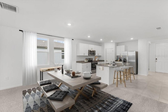 dining area featuring baseboards, visible vents, and recessed lighting
