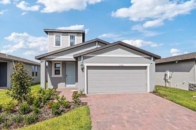 view of front of house featuring a garage and a front lawn