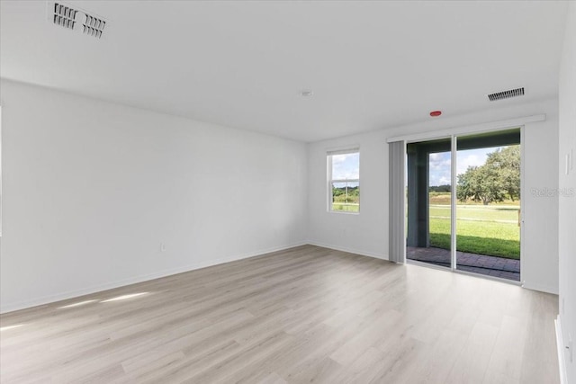 empty room with light hardwood / wood-style floors