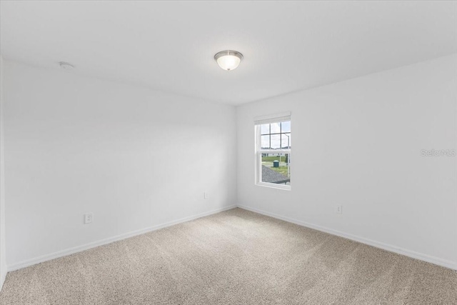 unfurnished room featuring light colored carpet