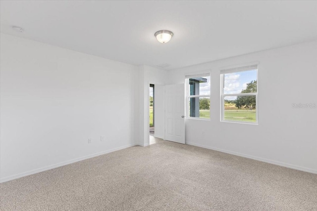 unfurnished room with light colored carpet