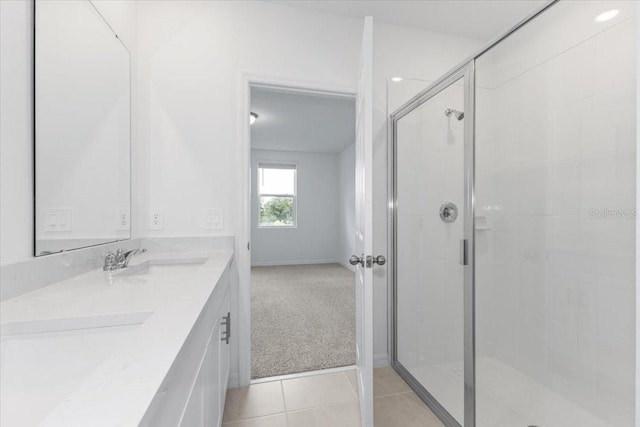 bathroom with tile patterned flooring, an enclosed shower, and vanity