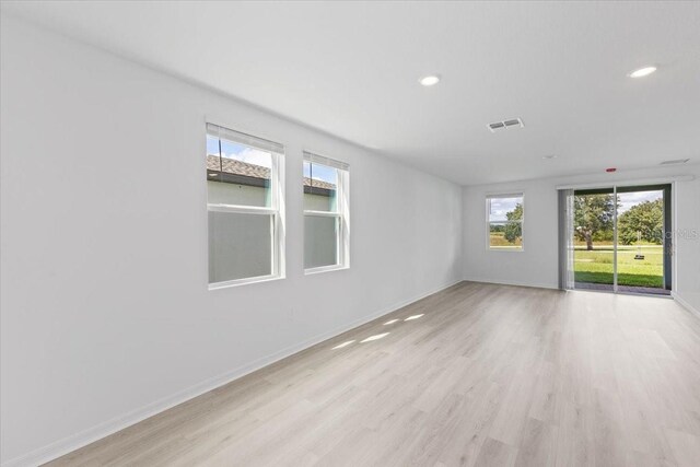 spare room with light hardwood / wood-style flooring