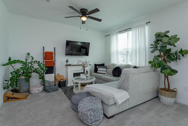 carpeted living room with ceiling fan