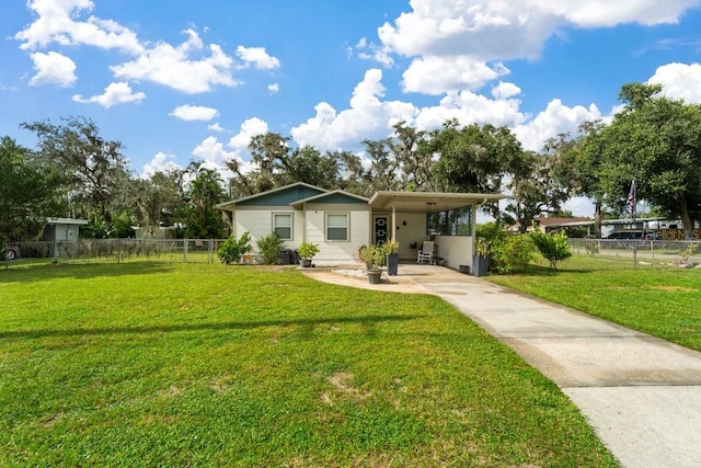 single story home featuring a front lawn and a carport