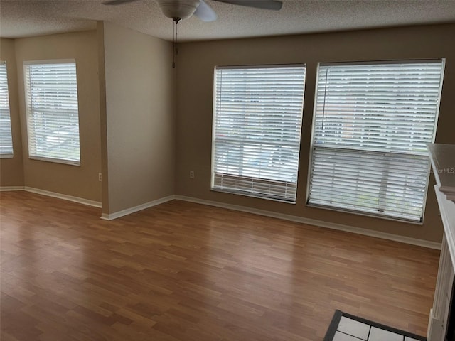 unfurnished room with a textured ceiling, ceiling fan, and hardwood / wood-style floors