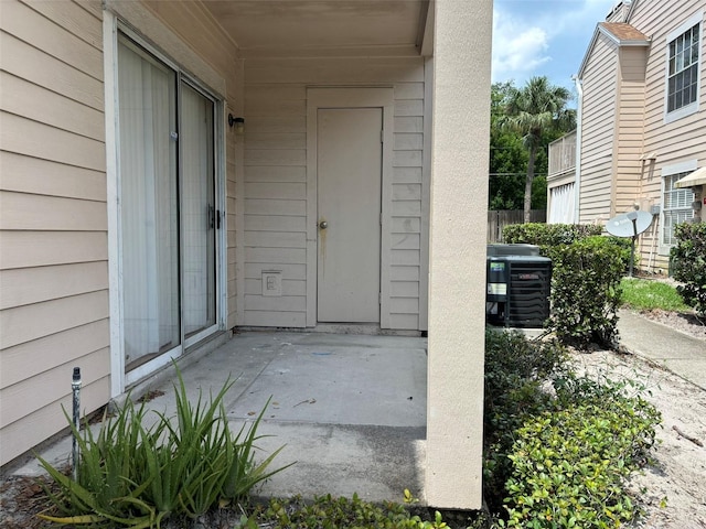 entrance to property featuring a patio area and central AC