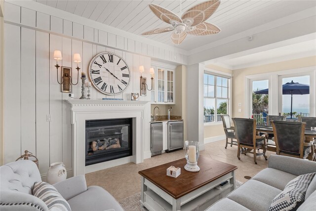 tiled living room with ceiling fan and wood ceiling