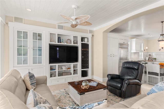 living room featuring wood ceiling, crown molding, and ceiling fan