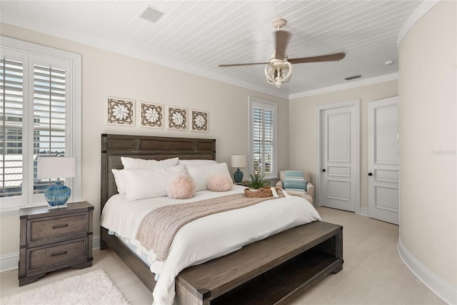 bedroom featuring ornamental molding, ceiling fan, a closet, wood ceiling, and light colored carpet