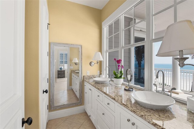 bathroom with vanity, a water view, and tile patterned flooring