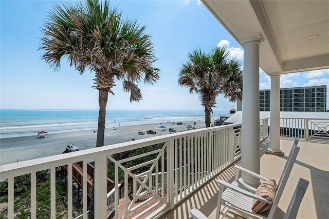 balcony with a beach view and a water view