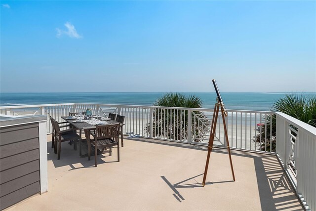 view of patio with a balcony and a water view