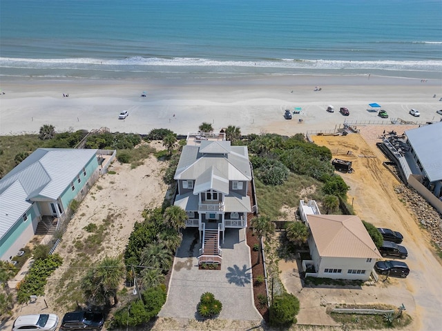 birds eye view of property with a beach view and a water view