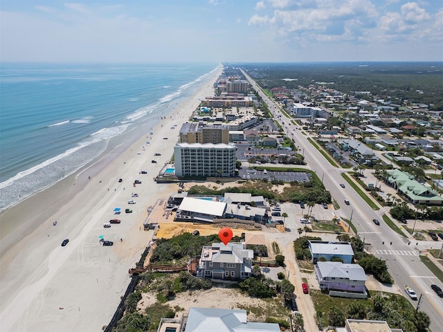 drone / aerial view with a water view and a view of the beach