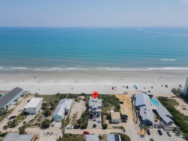 birds eye view of property with a view of the beach and a water view