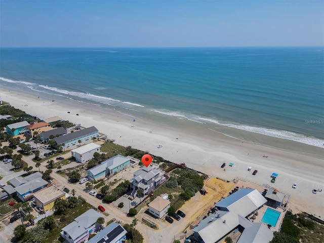 birds eye view of property featuring a view of the beach and a water view