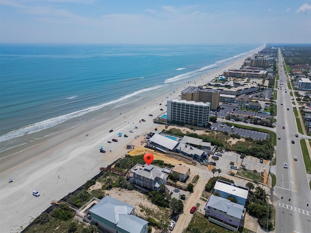 birds eye view of property with a view of the beach and a water view