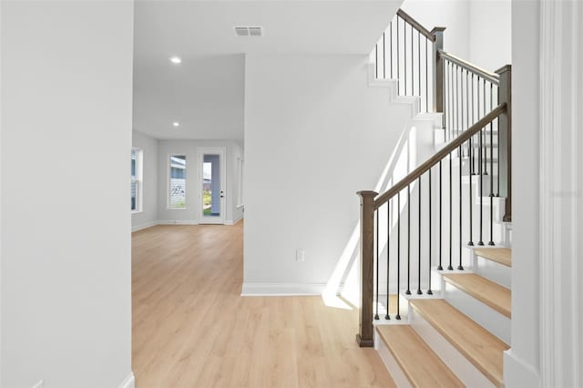 stairway with hardwood / wood-style floors