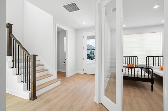 foyer entrance with light hardwood / wood-style flooring