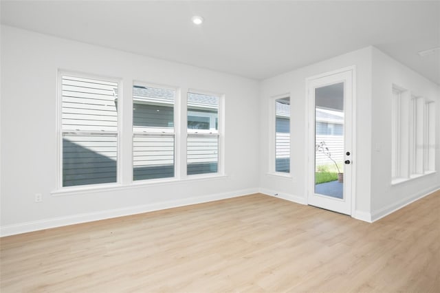 unfurnished room with light hardwood / wood-style floors