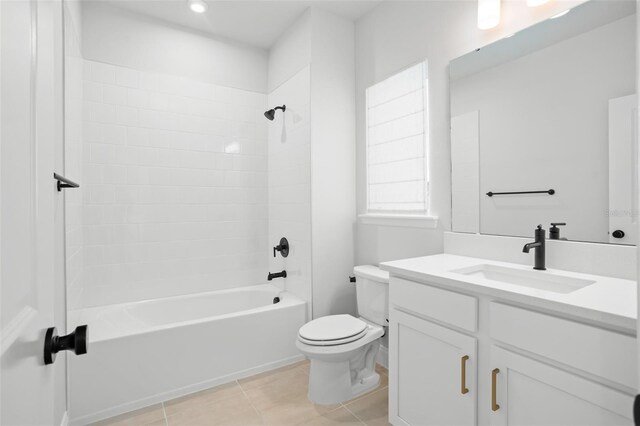 full bathroom featuring tile patterned floors, tiled shower / bath combo, vanity, and toilet